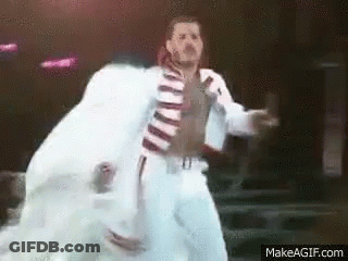 Man In White Suit Dancing On Stage GIF