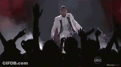 Man In White Suit Dancing On Stage GIF