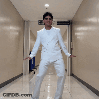 Man In White Suit Dancing Under GF Sign GIF