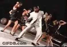 Man In White Suit Dancing With Women GIF