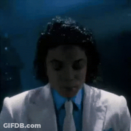 Man In White Suit Eyes Closed In Dark Room GIF