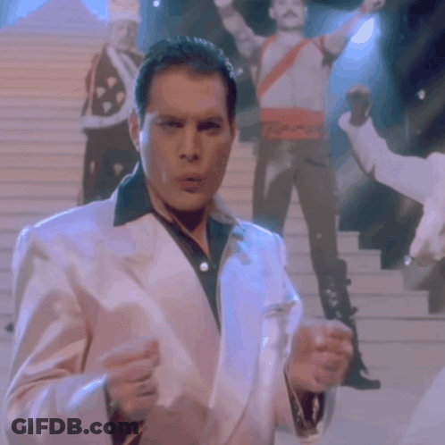 Man In White Suit Holding Glass GIF