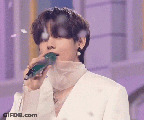 Man In White Suit Holding Green Microphone In Mouth GIF