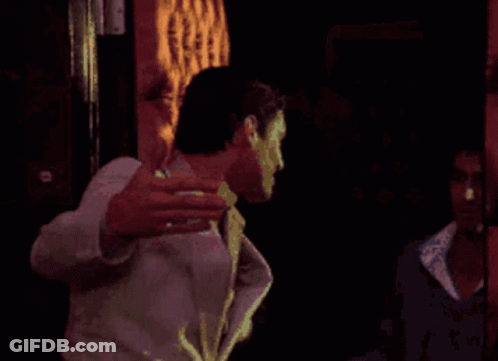 Man In White Suit Holding Gun GIF