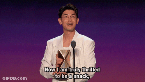 Man In White Suit Holding Trophy Says Now I Am Truly Thrilled To Be A Snack GIF