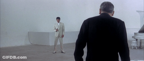Man In White Suit In Front Of Piano GIF