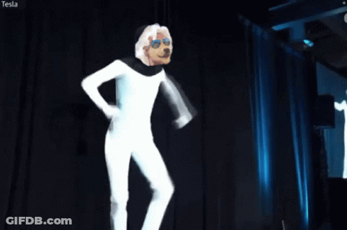 Man In White Suit In Front Of Tesla Screen GIF