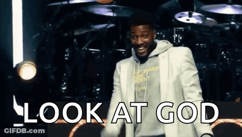 Man In White Suit On Stage With Look At God GIF