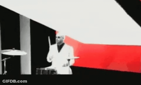 Man In White Suit Playing Drums GIF