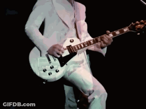 Man In White Suit Playing White Guitar GIF