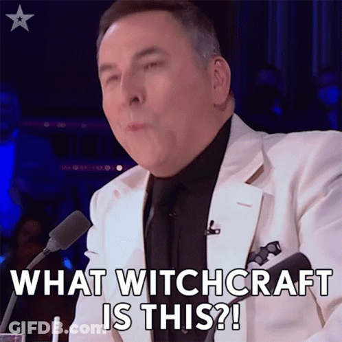 Man In White Suit Saying What Witchcraft Is This Into Microphone GIF