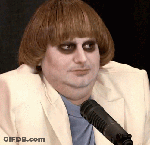Man In White Suit Sitting At Microphone Eyes Closed GIF