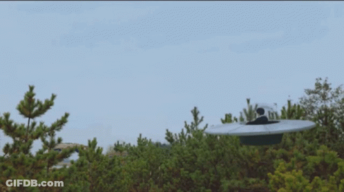 Man In White Suit Sitting On Roof Next To Woman With Pink Hair GIF