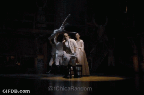 Man In White Suit Standing On Stage With @ 1Chicarandom GIF