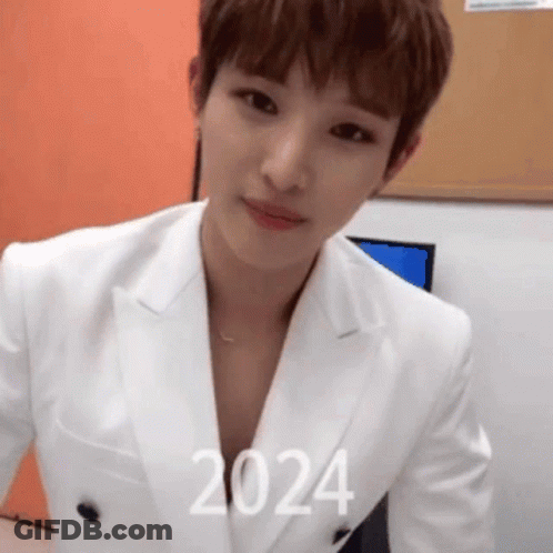 Man In White Suit With 2024 On Chest GIF