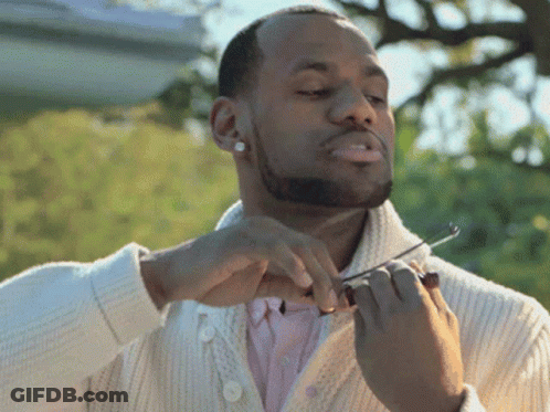 Man In White Sweater Holding Scissors GIF