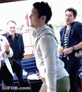 Man In White Sweater In Crowd GIF