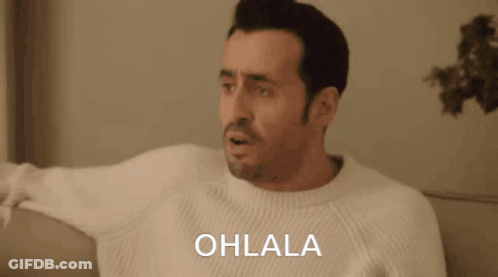 Man In White Sweater On Couch Saying Ohlala GIF