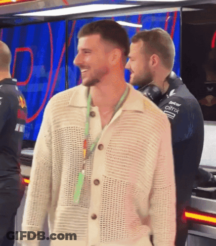 Man In White Sweater With Citrix Lanyard GIF