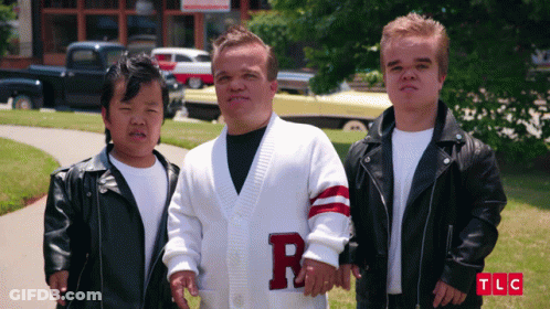 Man In White Sweater With Letter R On Sleeve GIF