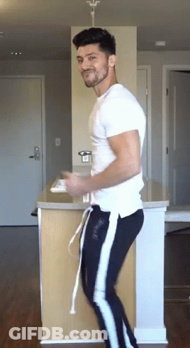 Man In White T-Shirt And Black Pants Dancing In Kitchen GIF