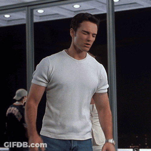 Man In White T-Shirt And Blue Jeans By Window GIF