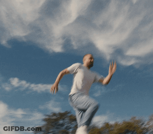 Man In White T-Shirt And Blue Jeans Jumping GIF