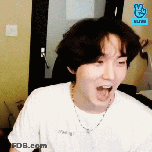 Man In White T-Shirt And Necklace Making Funny Face GIF