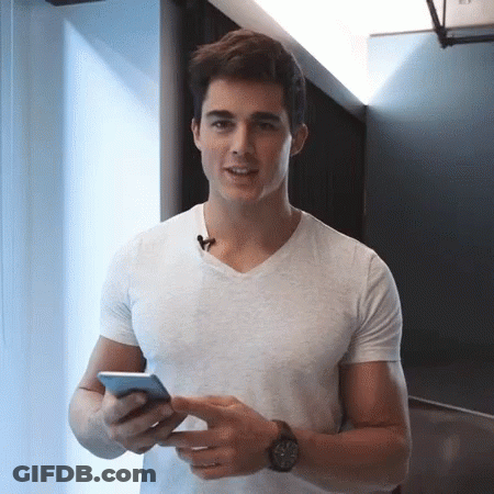 Man In White T-Shirt Holding Cell Phone GIF