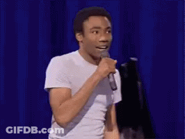 Man In White T-Shirt Holding Microphone GIF