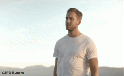 Man In White T-Shirt In Front Of Mountains GIF