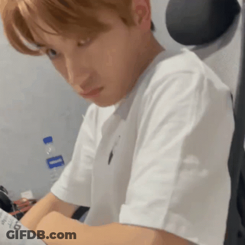 Man In White T-Shirt Sitting At Desk With Water Bottle GIF