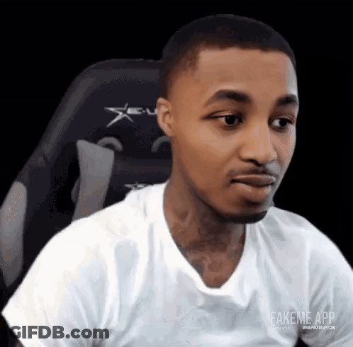 Man In White T-Shirt Sitting Making Funny Face GIF