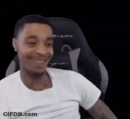 Man In White T-Shirt Smiling In Gaming Chair GIF