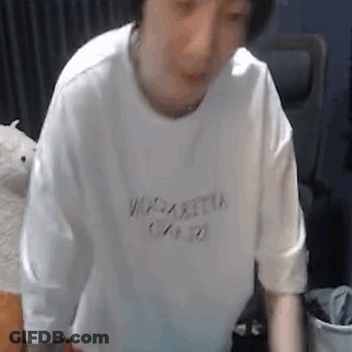 Man In White T-Shirt Standing By Chair GIF