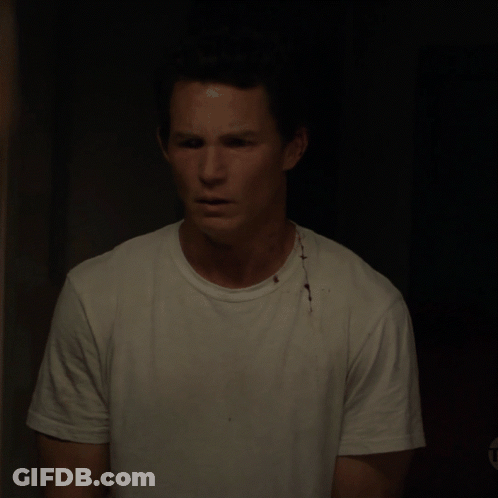 Man In White T-Shirt With Bloody Spot On Chest GIF