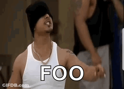 Man In White Tank Top And Black Hat Standing In Front Of Crowd GIF