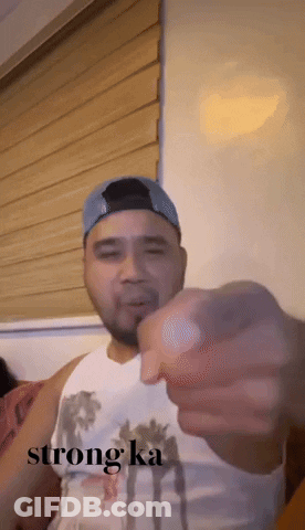 Man In White Tank Top And Blue Hat Pointing Saying Strong Ka GIF