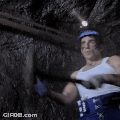 Man In White Tank Top And Blue Helmet Holding Hammer GIF