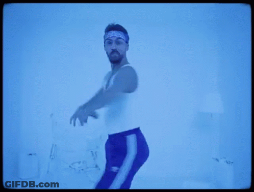 Man In White Tank Top And Blue Pants GIF