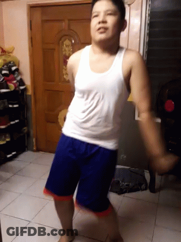 Man In White Tank Top And Blue Shorts Dancing GIF