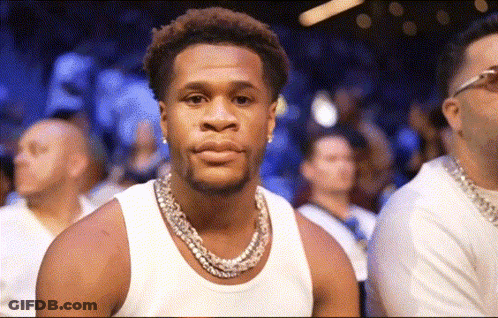 Man In White Tank Top And Necklace Looking At Camera GIF