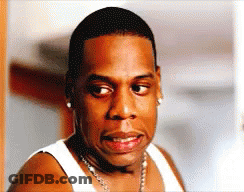 Man In White Tank Top And Necklace Looking At Camera GIF