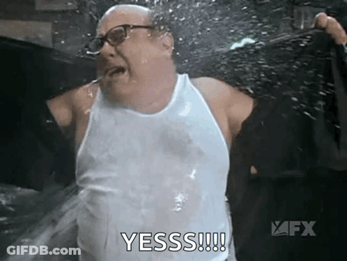 Man In White Tank Top Being Sprayed GIF