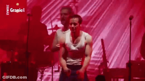 Man In White Tank Top Dancing Against Red Background GIF
