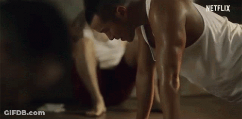 Man In White Tank Top Doing Push-Ups GIF