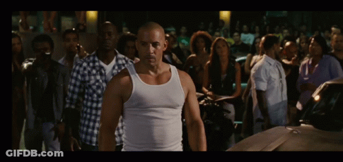 Man In White Tank Top Facing Crowd GIF