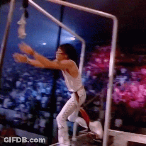 Man In White Tank Top Hanging From Bar GIF