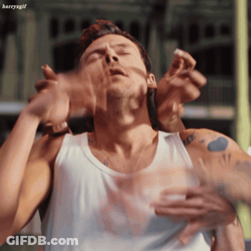 Man In White Tank Top Held By Another Man GIF
