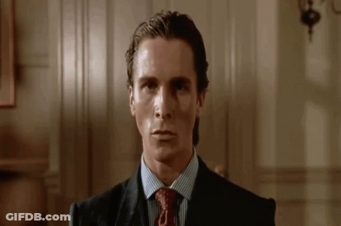 Man In White Tank Top Holding Belt In Doorway GIF